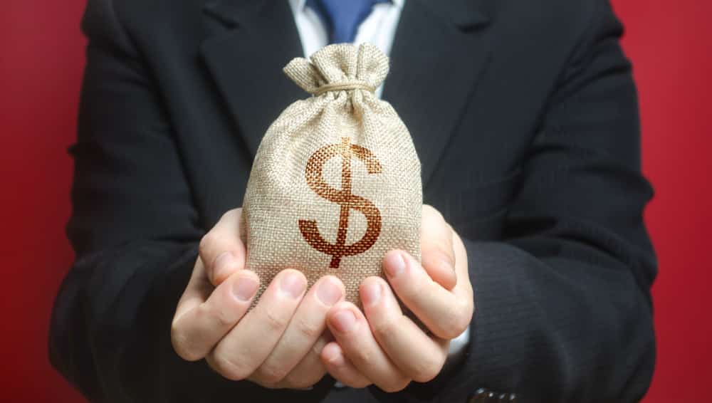 man holding a bag of cash