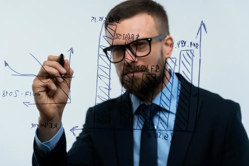 man draws various growth charts calculating prospe PKCASUU