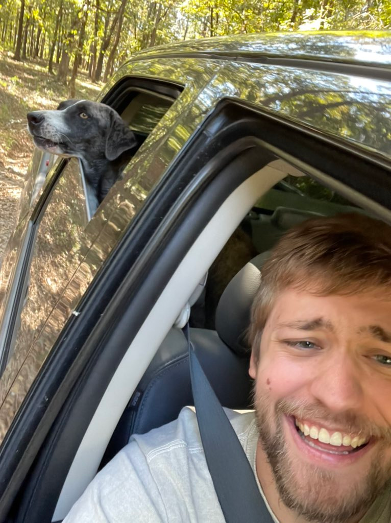 sodapoppin in a car with his black dog