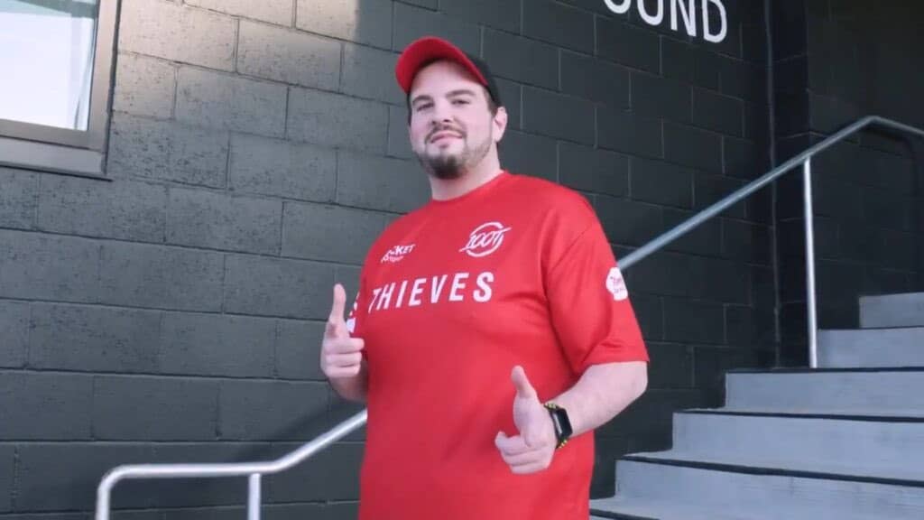 Hiko wearing a red t shirt from 100 Thieves