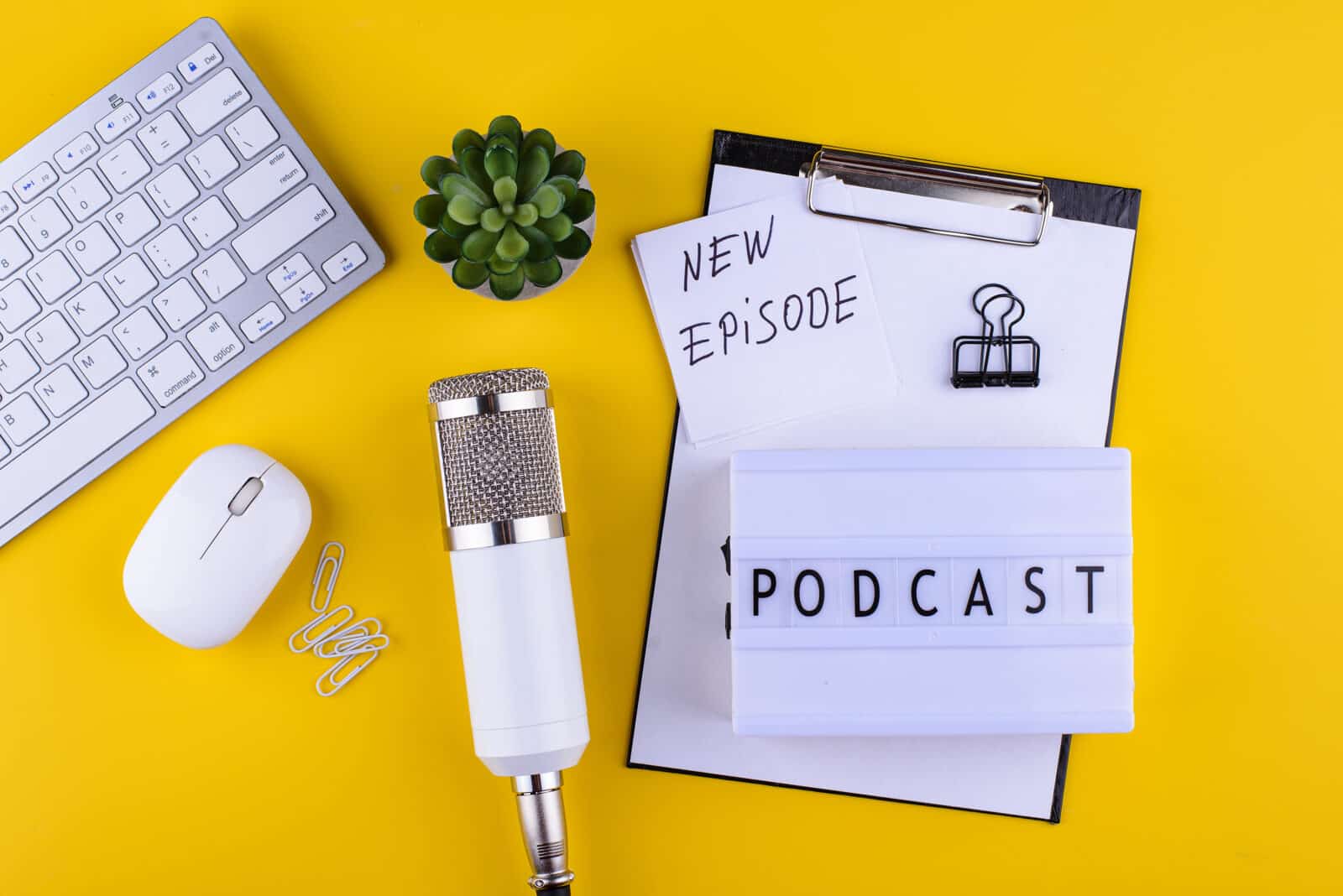Podcast new episode concept. Workplace desk of blogger or podcaster with microphone